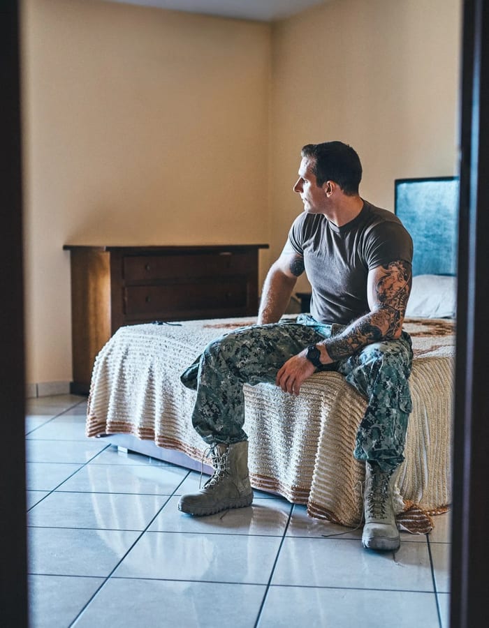 A person looking out a window with quiet hope